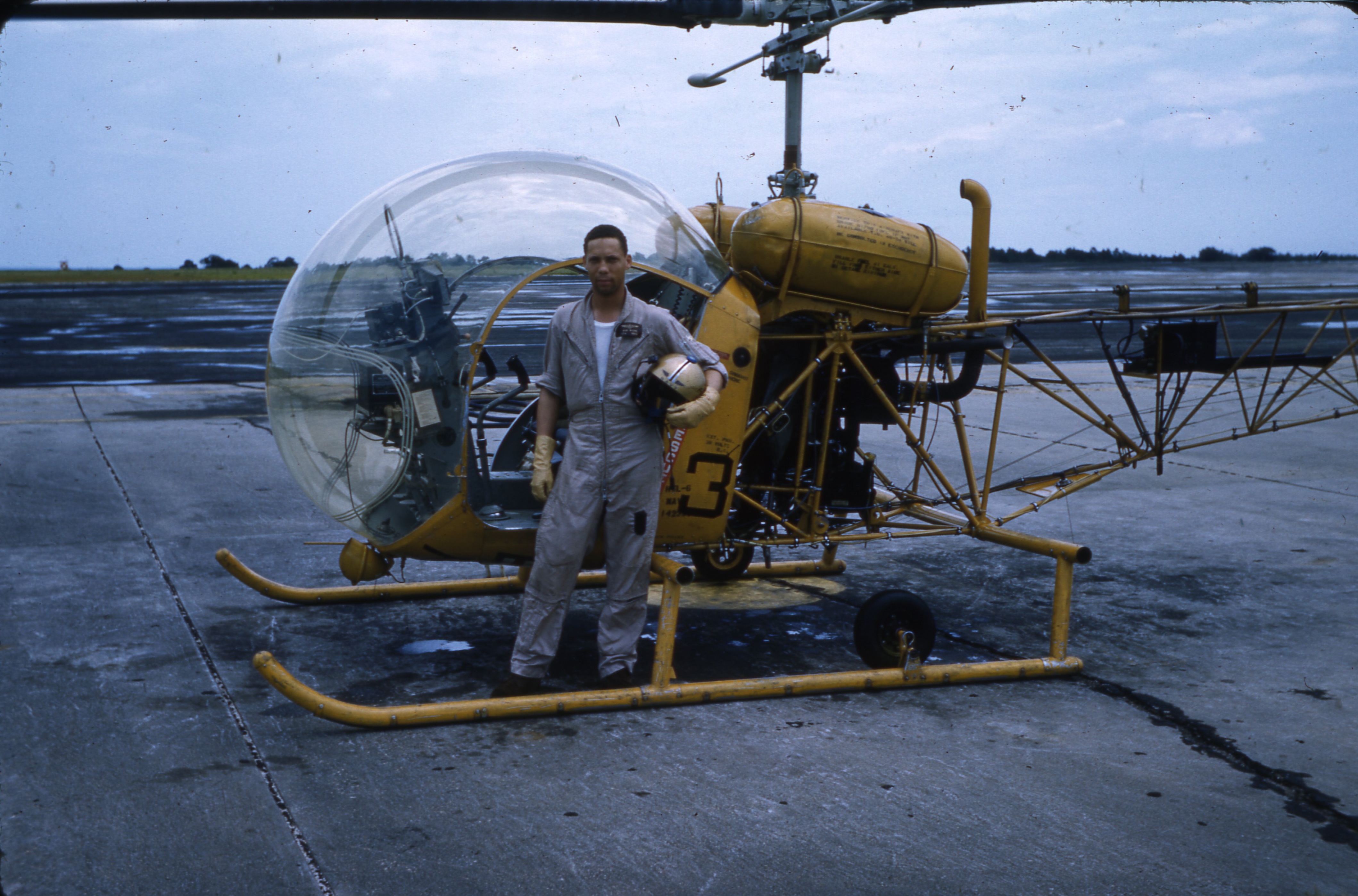 A color picture of LT Bobby Wilks standing in front of a helicopter at Naval Air Station Ellyson Field in August 1959. (U.S. Coast Guard) A color picture of LT Bobby Wilks standing in front of a helicopter at Naval Air Station Ellyson Field in August 1959. (U.S. Coast Guard)
